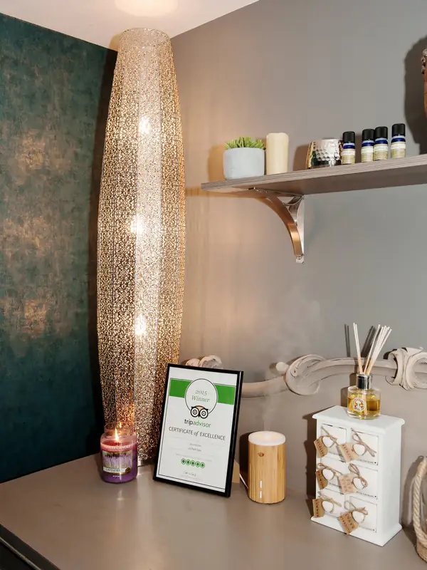 Treatment room shelf with Tripadvisor certificate
